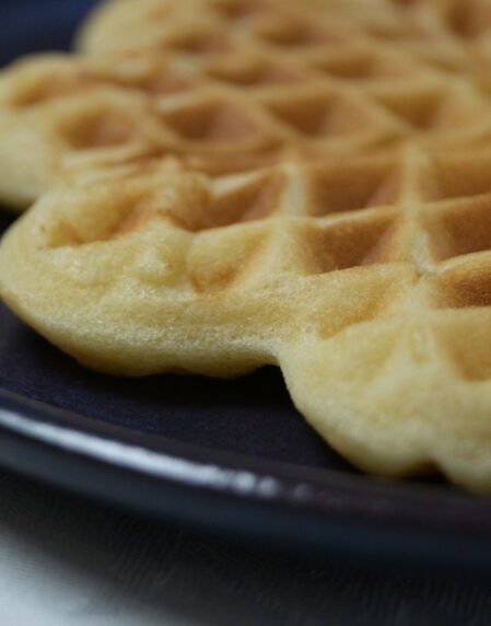 two waffles on a blue plate on a table