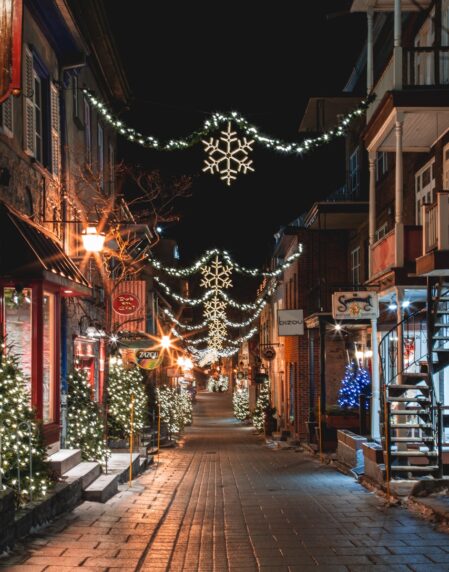 a city street is decorated with christmas lights